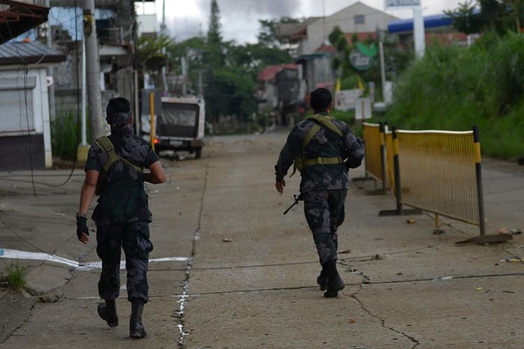 Dua orang anggota pasukan khusus kepolisian ini tengah berpatroli di jalanan yang kosong  ditinggalkan penduduk di kota Marawi.