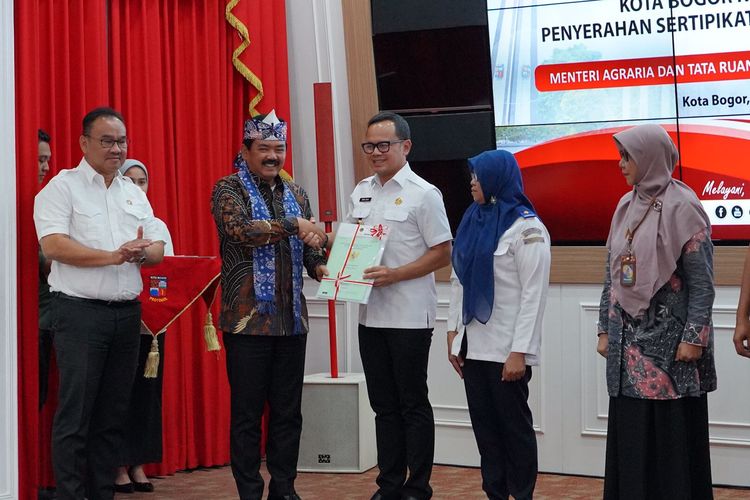 Penyerahan sertifikat aset dari Menteri ATR/Kepala BPN Hadi Tjahjanto kepada Walikota Bogor Bima Arya di Kantor Walikota Bogor pada Rabu (27/9/2023).