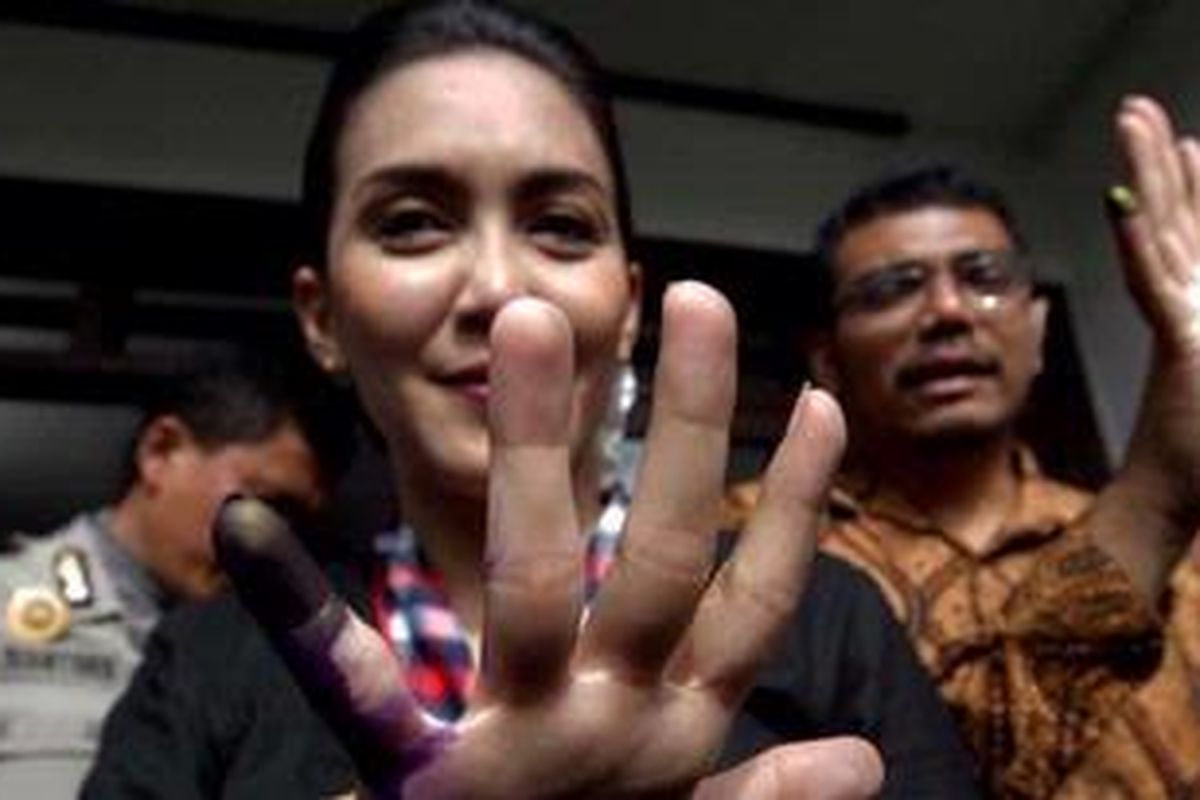 Calon Gubernur Jawa Barat, Rieke Diah Pitaloka didampingi suaminya, Donny Gahral Adian usai menggunakan hak pilihnya pada Pemilihan Kepala Daerah (Pilkada) Jawa Barat 2013 di Tempat Pemungutan Suara 20, Kukusan, Depok, Jawa Barat, Minggu (24/2/2013). Lima pasangan calon gubernur dan wakil gubernur Jawa Barat bertarung pada pemilihan gubernur Jabar periode 2013-2018. 