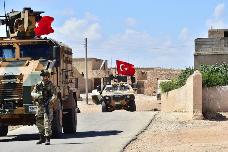 Foto yang dirilis Pasukan Bersenjata Turki memperlihatkan tentara Turki didampingi kendaraan lapis baja berpatroli di kota Manbij di Suriah utara, Senin (18/6/2018).