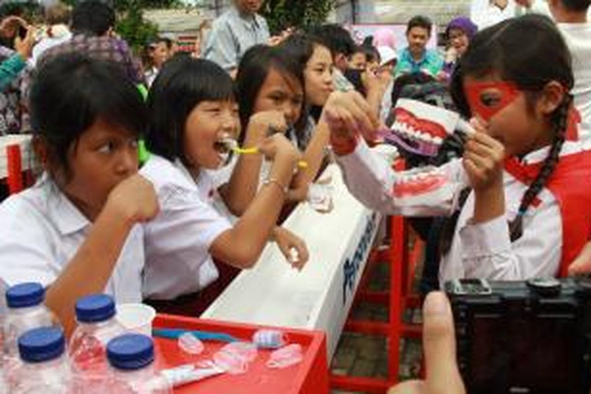 Anak-anak SD Babakan Madang 1, Sentul, Bogor, menyikat gigi bersama pada perayaan Hari Kesehatan Gigi Sedunia pada 20 Maret 2015.