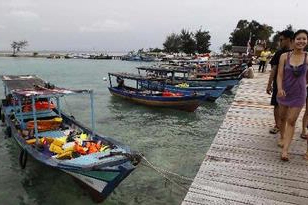 Wisatawan mandi dan bermain di jembatan yang menghubungkan Pulau Tidung Besar dan Pulau Tidung Kecil, di Kepulauan Seribu, Sabtu (14/5/2011). Pulau ini kian dikenal sebagai salah satu destinasi wisata bahari. Pada hari libur, pulau yang memiliki lebar sekitar 200 meter dan panjang hanya 5 kilometer, ini ramai dikunjungi wisatawan. 