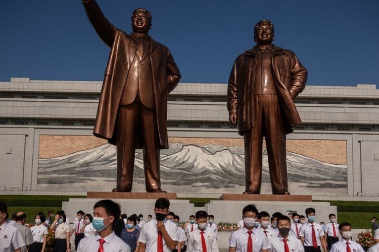 Orang-orang memberi penghormatan di depan patung mendiang pemimpin Korea Utara Kim Il Sung dan Kim Jong Il di Bukit Mansu saat Korea Utara menandai Hari Pembebasan Nasional ke-76, memperingati berakhirnya pemerintahan kolonial Jepang pada akhir Perang Dunia II, di Pyongyang pada 15 Agustus 2021. 