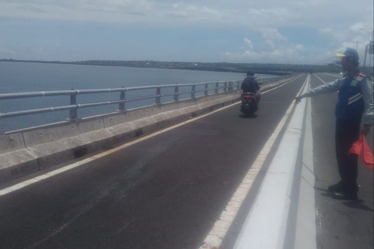 Petugas menunjukan lokasi terjadinya kecelakaan di Tol Bali Mandara, Sabtu (1/2/2020).