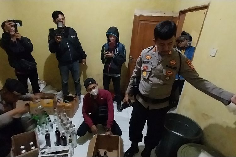 Petugas Satuan Sabhara Polresta Tasikmalaya, Jawa Barat, mengamankan ratusan botol miras impor palsu hasil racikan seorang pria di kamar kos yang dijadikan gudang miras di Jalan Cieunteung Gede, Linggajaya, Mangkubumi, Kota Tasikmalaya, Senin (5/6/2023).