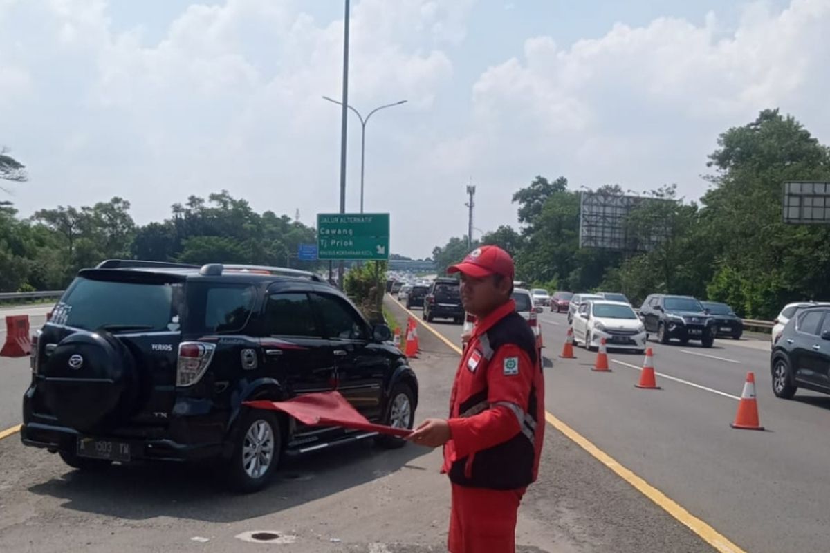 Petugas Tol Jagorawi sedang mengarahkan kendaraan setelah diberlakukan Contraflow di ruas tol arah Jakarta dari Km 17+200 sampai Km 11+700 Tol Jagorawi, Sabtu (22/4/2023)