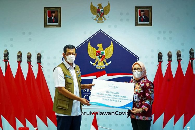 Direktur Konsumer dan Ritel Bank BJB Suartini saat menyerahkan bantuan dari Bank BJB kepada Kepala Badan Nasional Penanggulangan Bencana (BNPB) Letjen TNI Doni Monardo, Kamis (17/12/2020) 