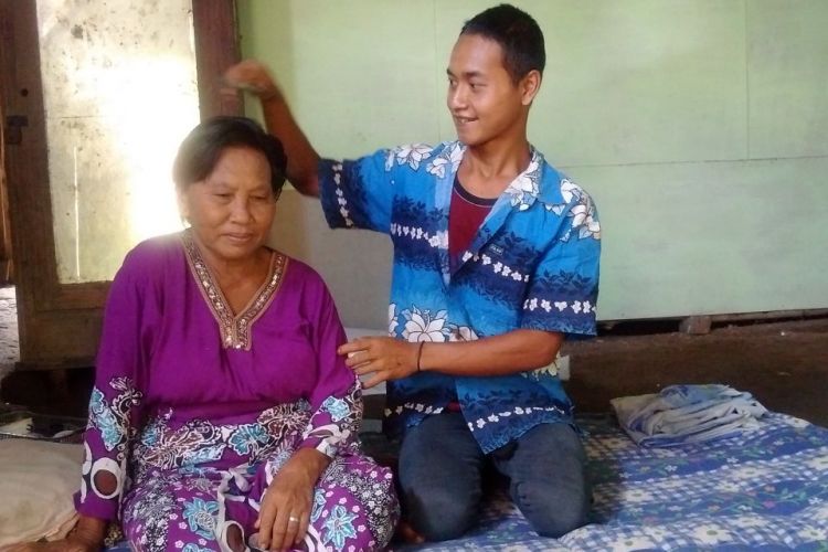 Rokim (24) menyisiri istrinya, Tampi, nenek berumur 67 tahun yang dinikahinya di Dusun Petung, Desa Nampu, Kecamatan Gemarang, Kabupaten Madiun, Jumat ( 17 / 3 / 2017) siang
