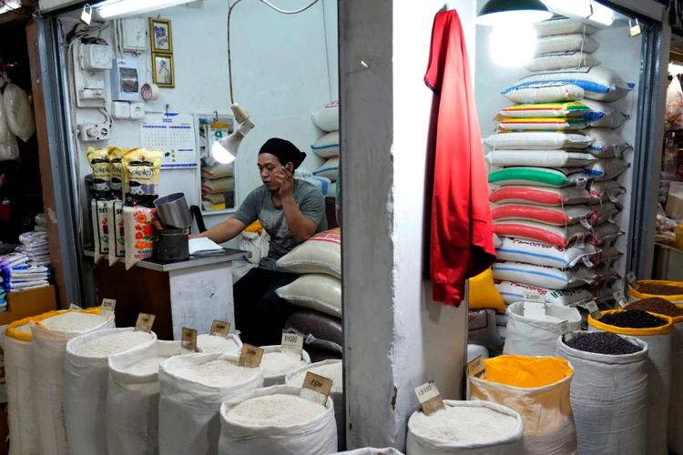 Seorang pedagang beras dan biji-bijian lainnya menunggu pelanggan di sebuah pasar di Jakarta, Minggu, 14 Agustus 2022.