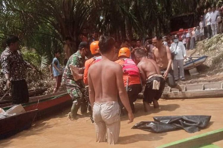 Petugas gabungan mengevakuasi salah satu korban hanyut di Sungai Batang Lubuh, Kecamatan Kepenuhan, Kabupaten Rokan Hulu, Riau, Sabtu (8/1/2022).