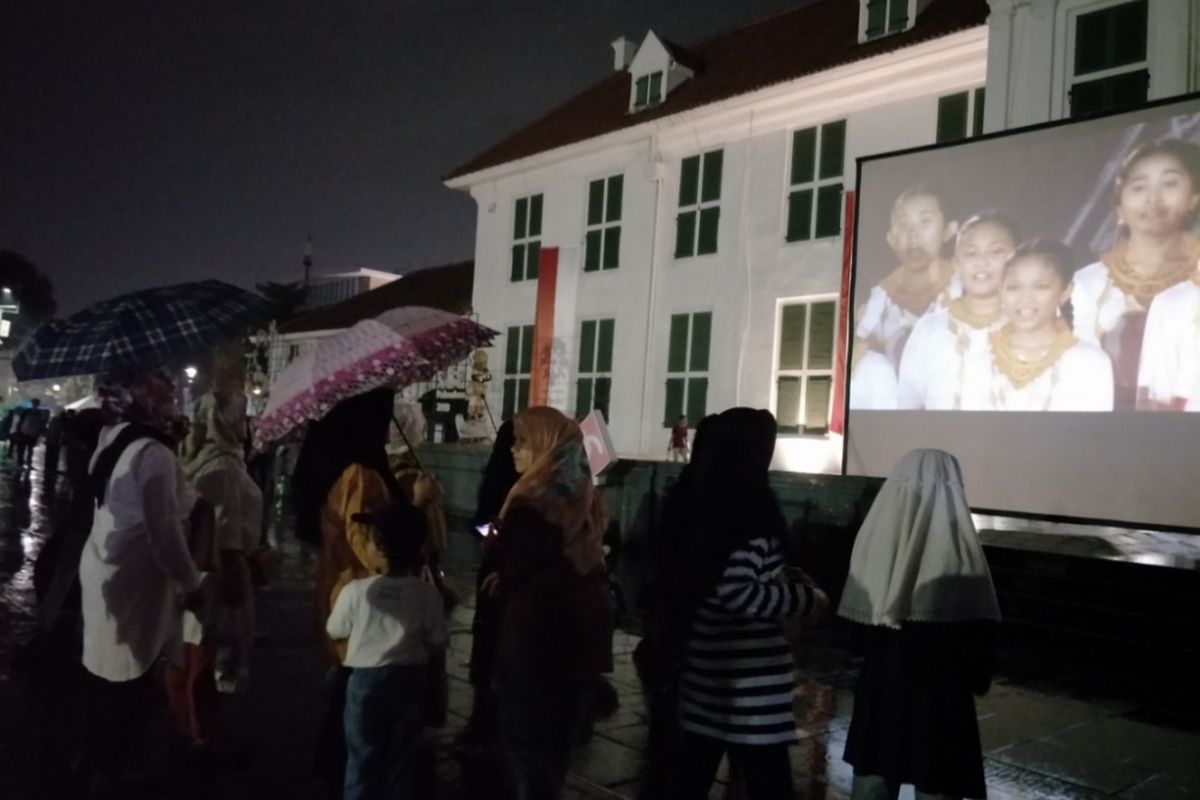 Gerimis tak menyurutkan minat warga untuk nonton bareng (nobar) closing ceremony Asian Games 2018 di pelataran Museum Fatahillah, Minggu (2/9/2018).