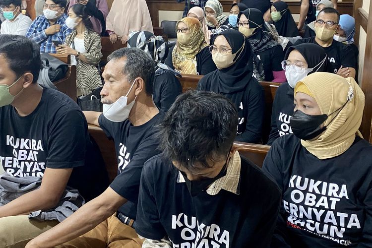 In this picture taken on February 7, 2023 parents of children, who they alleged were either killed or left sickened by tainted cough syrups, attend a hearing as part of a lawsuit at the South Jakarta district court, while wearing black shirts reading I thought it was medicine, it was poison to the court. Their class-action lawsuit targets the ministry of health, the country's food and drug agency, and eight companies implicated in selling the syrups -- which the World Health Organization said contain an unacceptable amount of diethylene glycol and ethylene glycol. 