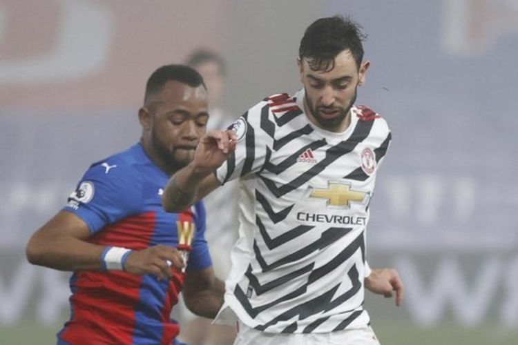 Bruno Fernandes (kanan) berduel dengan Jordan Ayew dalam pertandingan Crystal Palace vs Manchester United pada pekan ke-29 Premier League 2020-2021 yang dilangsungkan di Stadion Selhurst Park, Rabu (3/3/2021) malam waktu setempat. 