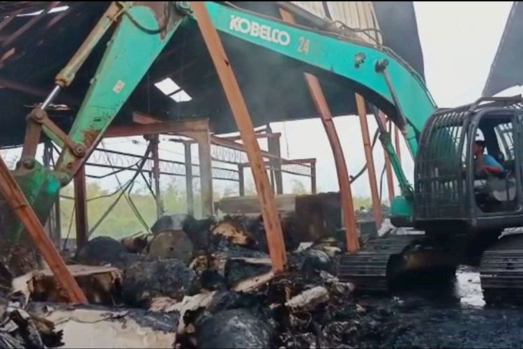Alat berat diterjunkan untuk mengevakuasi sisa-sisa runtuhan bangunan pabrik kertas pasca kebakaran.