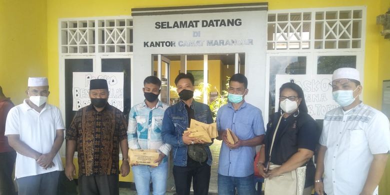 Kepala Dinas Sosial Tapanuli Selatan Nurdin Pane dan Pekerja Sosial (Peksos) Ahli Madya Direktorat Perlindungan Sosial Korban Bencana Sosial (PSKBS) Johanna Carolina menyerangkan santuan kepada ahli waris dari 12 korban tewas bencana tanah langsor di Kantor Camat Marancar, Tapanuli Selatan, Rabu (12/5/2021). 