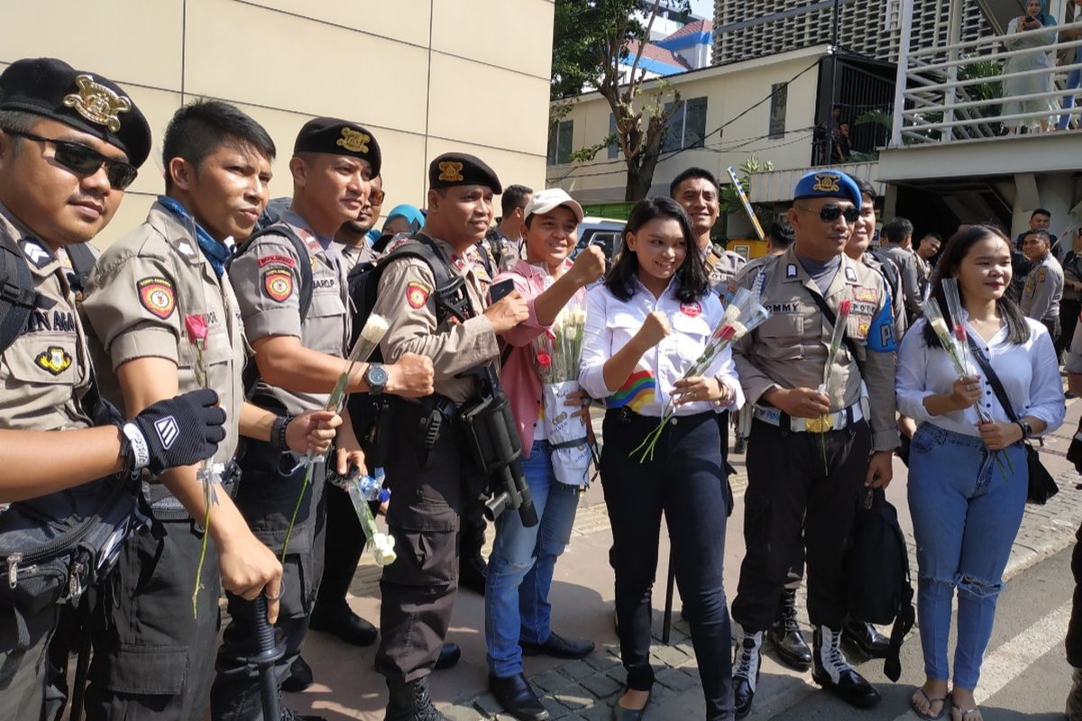 Sejumlah Mahasiswa Tergabung dalam Generasi Satu Indonesia membagikan 350 bunga di depan gedung Bawaslu RI