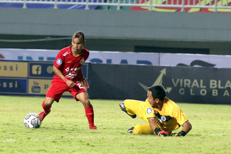 Pemain Persija Jakarta Riko Simanjuntak mengecoh penjaga gawang PS Sleman Ega Rizky pada pekan 1 Liga 1 2021-2022 yang berakhir dengan skor 1-1 di Stadion Pakansari Bogor, Minggu (5/9/2021) malam.