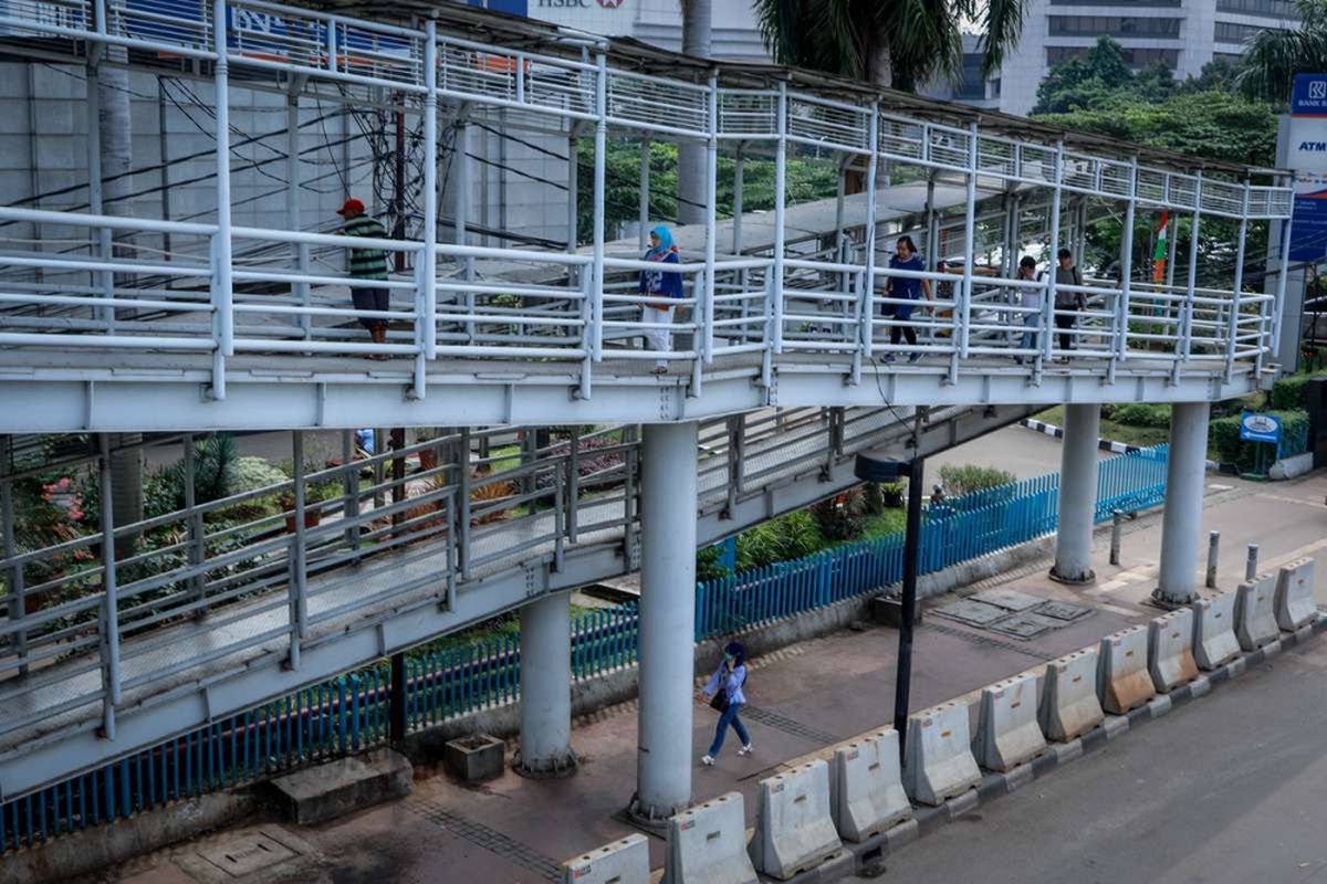 Warga melintasi jembatan penyeberangan orang (JPO) di Dukuh Atas, Jakarta, Sabtu (28/4/2018). Pemerintah Provinsi DKI Jakarta akan merombak 12 JPO di sepanjang Jalan Jenderal Sudirman hingga Jalan MH Thamrin.