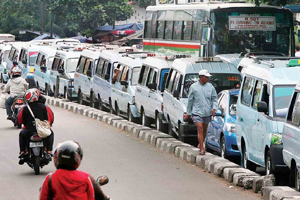 Angkutan umum M09 dan M11 memenuhi Jalan KS Tubun, Jakarta, Rabu (29/6). Pada masa libur, sebagian besar angkutan umum tersebut sepi penumpang sehingga berjalan perlahan sambil menunggu penumpang. Selain menyebabkan kemacetan panjang, hal itu juga mengakibatkan pemborosan bahan bakar.