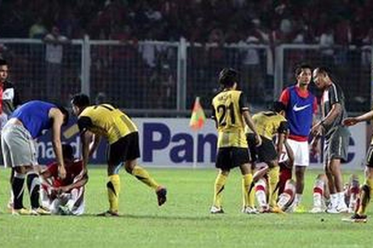Pemain Malaysia memberikan semangat kepada pemain U23 Indonesia usai pertandingan final SEA Games XXVI di Stadion Gelora Bung Karno, Jakarta Pusat, Senin (21/11/2011). Malaysia mengalahkan Indonesia lewat adu penalti dengan skor 5-4, setelah bermain imbang 1-1 selama dua babak waktu normal.