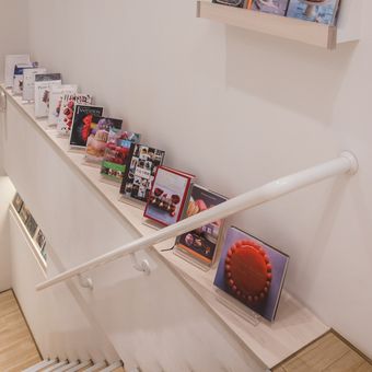 Ilustrasi memajang koleksi buku di area tangga. 