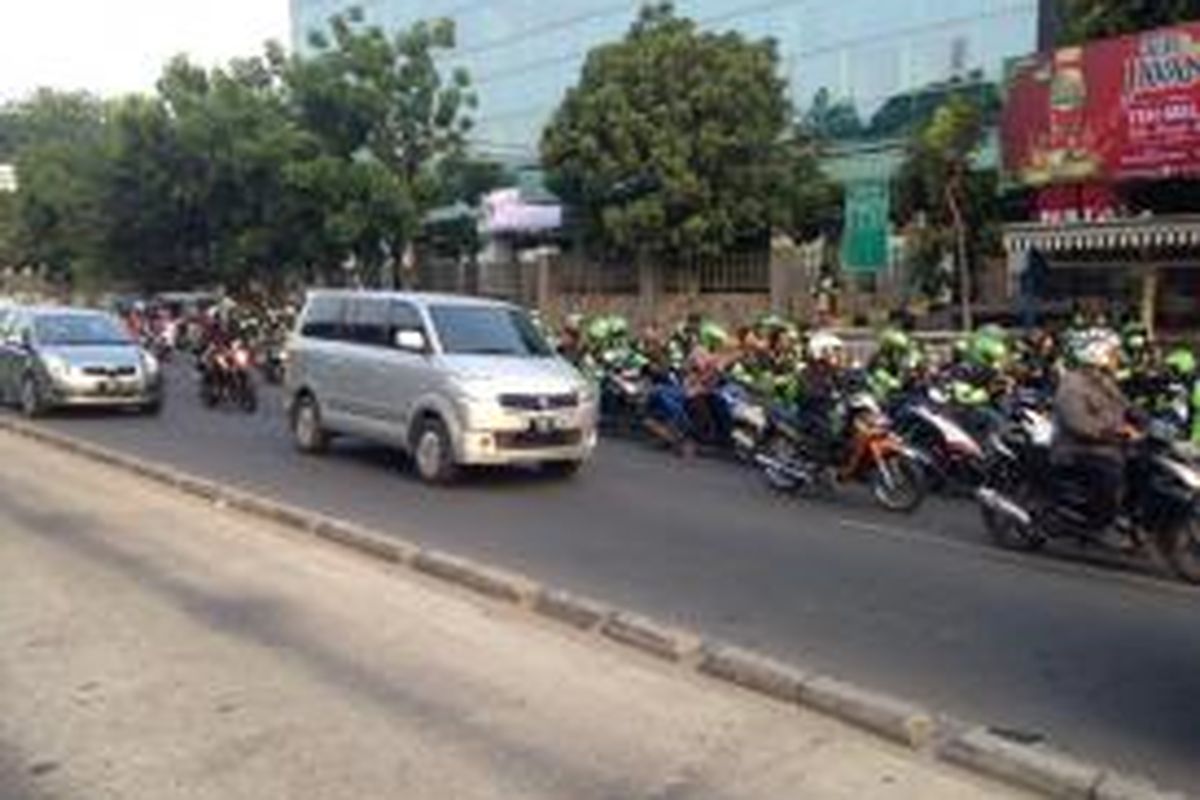 Ratusan pengojek berbasis aplikasi dari Grab Bike memenuhi dua ruas jalan dekat Rumah Sakit Tarakan, Jakarta Pusat, Sabtu (19/9/2015). Ratusan pengojek Grab Bike memenuhi ruas jalan di kedua arah sejak pukul 11.00 WIB sebagai bentuk solidaritas terhadap salah satu pengojeknya yang meninggal akibat kecelakaan. 