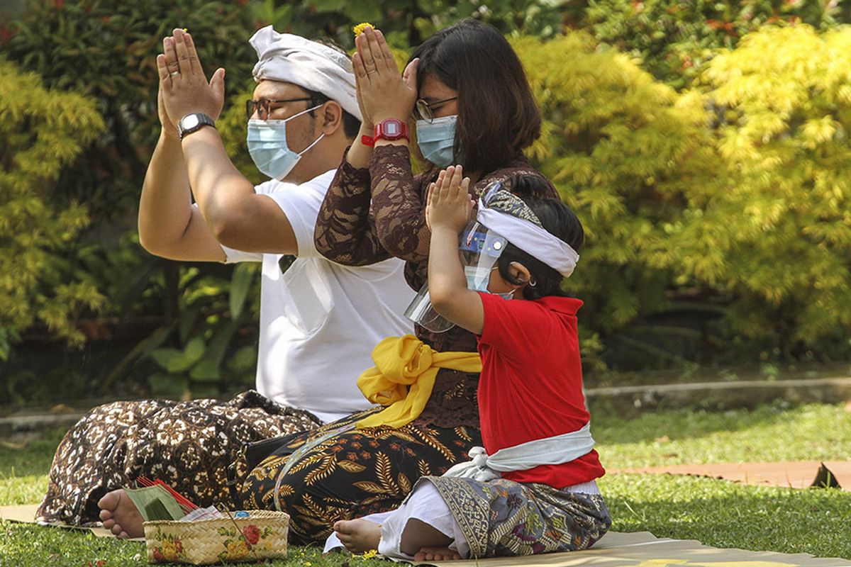 Umat Hindu beribadah saat merayakan hari raya Galungan di Pura Amerta Jati, Jakarta Selatan, Rabu (16/9/2020). Persembayangan Hari Raya Galungan dilakukan di tengah pandemi COVID-19 dengan menerapkan protokol kesehatan menggunakan masker dan menjaga jarak.