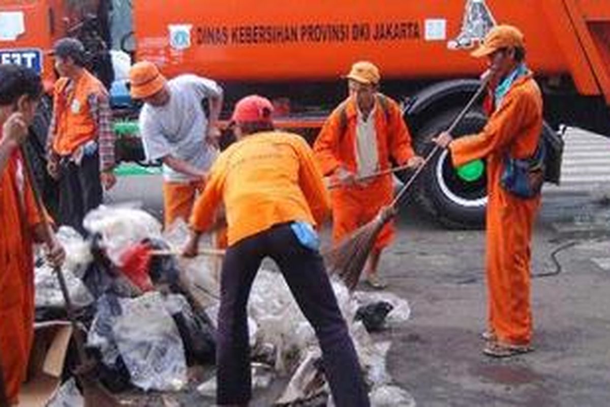 Petugas Kebersihan membersihkan sampah di ruas jalan Bekasi Barat, Jatinegara, Jakarta Timur, Jumat (10/9/2010). 
