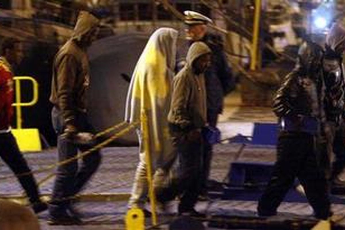 North African migrants fleeing Libya arrive at the port in the southern Sicily village of Porto Empedocle late on March 27, 2011 the first such group to reach Europe since the start of the uprising against Moamer Kadhafi. Three boats carried around 800 people -- mostly Eritreans, Ethiopians and Somalians -- and were taken to the tiny outcrop of Linosa close to the larger island of Lampedusa where thousands have been arriving from Tunisia.