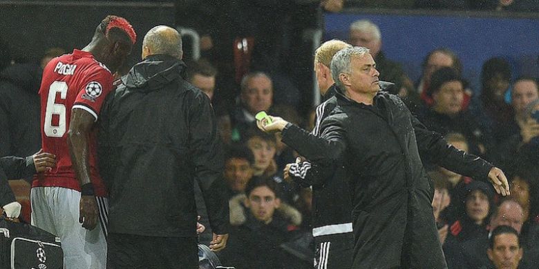 Manajer Manchester United, Jose Mourinho (kanan), melempar ban kapten yang sebelumnya dipakai Paul Pogba (kiri), kepada Ashley Young dalam laga penyisihan Grup A Liga Champions melawan Basel di Stadion Old Trafford, Manchester, Inggris, 12 September 2017. Pogba Ditarik keluar akibat cedera.