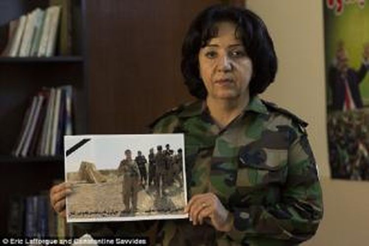 Kolonel Rashid, sambil memegang foto seorang pejuang yang tewas, mengatakan dirinya tidak gentar oleh ancaman pernikahan ISIS.