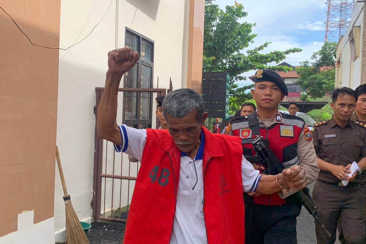 Ketua Masyarakat Adat Ompu Umbak Siallagan, Sorbatua Siallagan, mengangkat dan mengepalkan tangan saat berada di Pangadilan Negeri (PN) Simalungun.