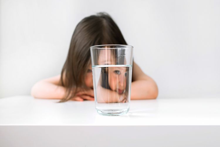 Ilustrasi anak minum air putih, efek terlalu banyak minum air putih, anak berisiko stunting akibat pemberian air putih berlebihan