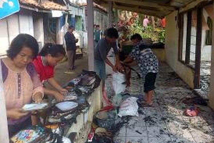 Warga membantu menyelamatkan buku-buku sekolah dari rumah Bahrun (80) di  Rt 1 Rw 1 Klego, Kelurahan Ngempon yang terbakar Kamis (14/8/2014) pagi. 
