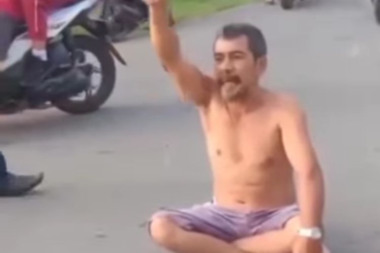 Potongan gambar video pria di Tapanuli Tengah yang depresi lalu menumpuk-numpuk uangnya ke tengah jalan. 