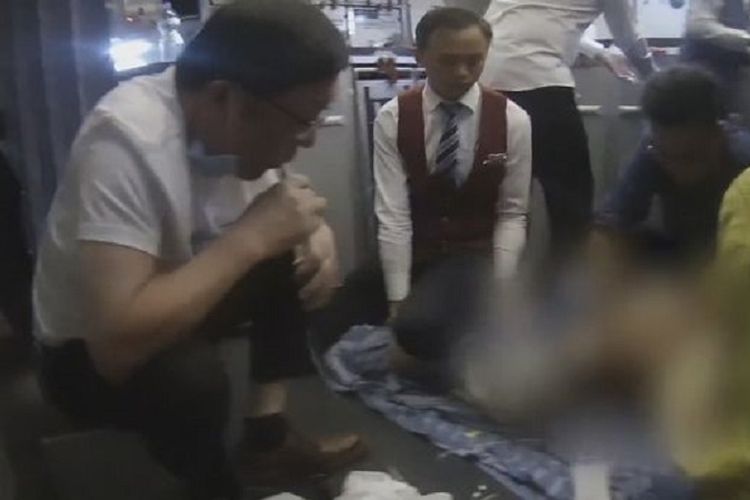 Dokter Zhang Hong ketika mengisap urine dari kandung kemih seorang penumpang di tengah penerbangan dari Guangzhou menuju New York, AS, 19 November lalu.
