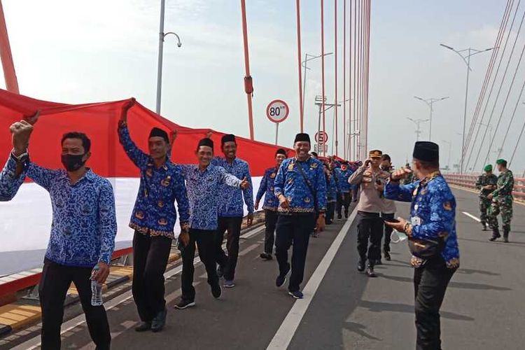 Para ASN yang sengaja membawa Bendera Merah Putih dengan ukuran raksasa di Jembatan Suramadu, Kamis (10/11/2022).