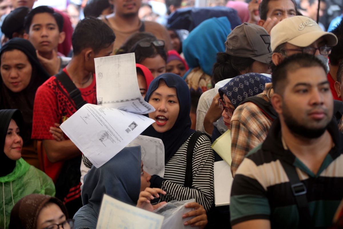 Warga antre menyerahkan berkas untuk pencetakan e-KTP di stan pelayanan dan pencetakan e-KTP di Taman Mini Indonesia Indah (TMII), Jakarta, Jumat (20/10/2017).  Kegiatan yang digelar antara Dinas Kependudukan dan Catatan Sipil DKI bekerja sama dengan Direktorat Jenderal Kependudukan dan Catatan Sipil Kementerian Dalam Negeri ramai diserbu warga yang yang belum memiliki e-KTP.