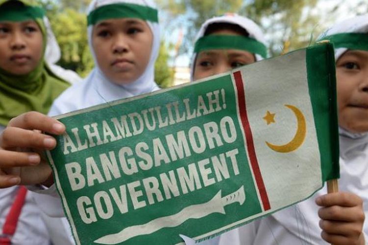 Anak-anak sekolah di Mindanao, Filipina selatan, melambaikan bendera Bangsamoro sebagai bentuk dukungan perjanjian damai antara MILF dan pemerintah Filipina yang diteken, Kamis (27/3/2014).