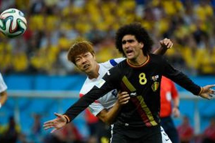 Bek Korea Selatan, Kim Young-Gwon (kiri) saat berebut bola dengan gelandang Belgia, Marouane Fellaini, pada pertandingan terakhir Grup H Piala Dunia 2014 di Arena de Sao Paulo, Kamis atau Jumat (27/6/2014) dini hari WIB.