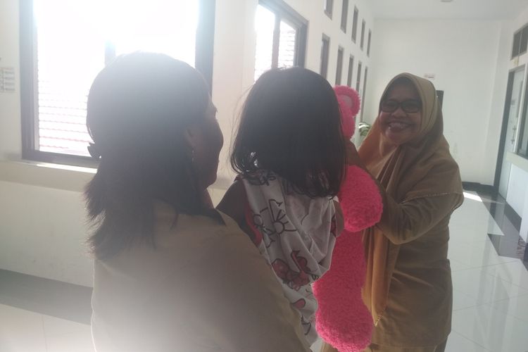 Kepala Dinas Perlindungan dan Pemberdayaan Perempuan dan Anak Kota Makassar Andi Tenri Palallo saat menghibur EA (2), bocah yang ditemukan di samping mayat ibunya di Rumah Sakit Bhayangkara Makassar, Selasa (29/10/2019).