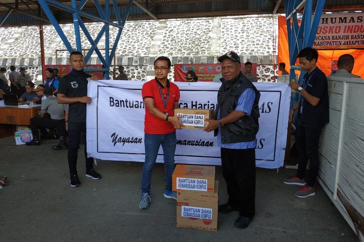 Group of Retail and Publishing Kompas Gramedia Regional 7, Guido Silvester Adrian C menyerahkan bantuan dari Kompas Gramedia kepada para korban bencana banjir bandang di Kabupaten Jayapura, Papua. Bantuan diterima oleh Bupati Jayapura Mathias Awaitouw di Pos Induk Sentani, Sabtu (23/3/2019).