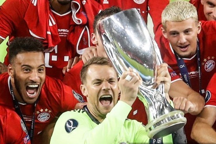 Kiper Bayern Muenchen, Manuel Neuer, mengangkat trofi Piala Super Eropa 2020.
