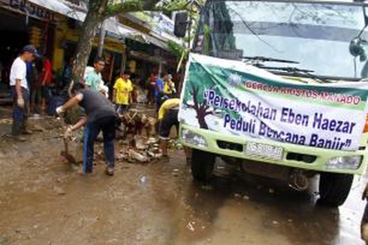 Sejumlah siswa di Manado ikut mengangkut sampah akibat terjangan banjir bandang.