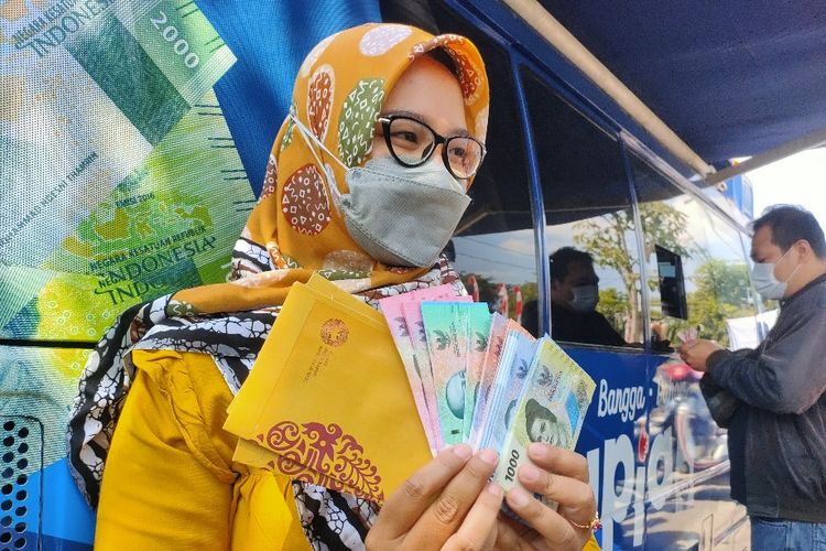Warga menunjukan 7 pecahan uang rupiah baru tahun emisi 2022 usai menukarkan uang lamanya di mobil kas keliling KPw Bank Indonesia Tegal, di kawasan Alun- alun, Kota Tegal, Jawa Tengah, Jumat (19/8/2022). 