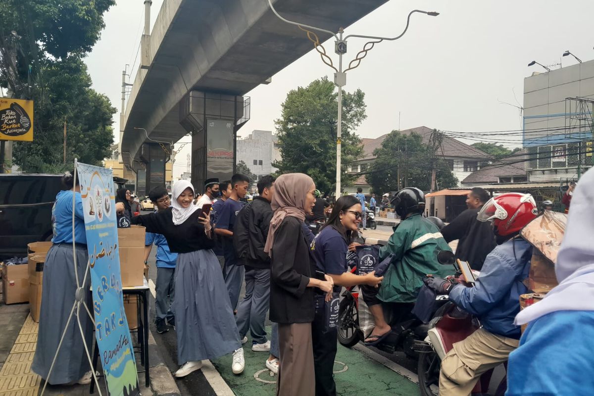 Guru dan murid SMA Cendrawasih 1, Jakarta Selatan berbagi takjil di Jalan Raya RS Fatmawati 