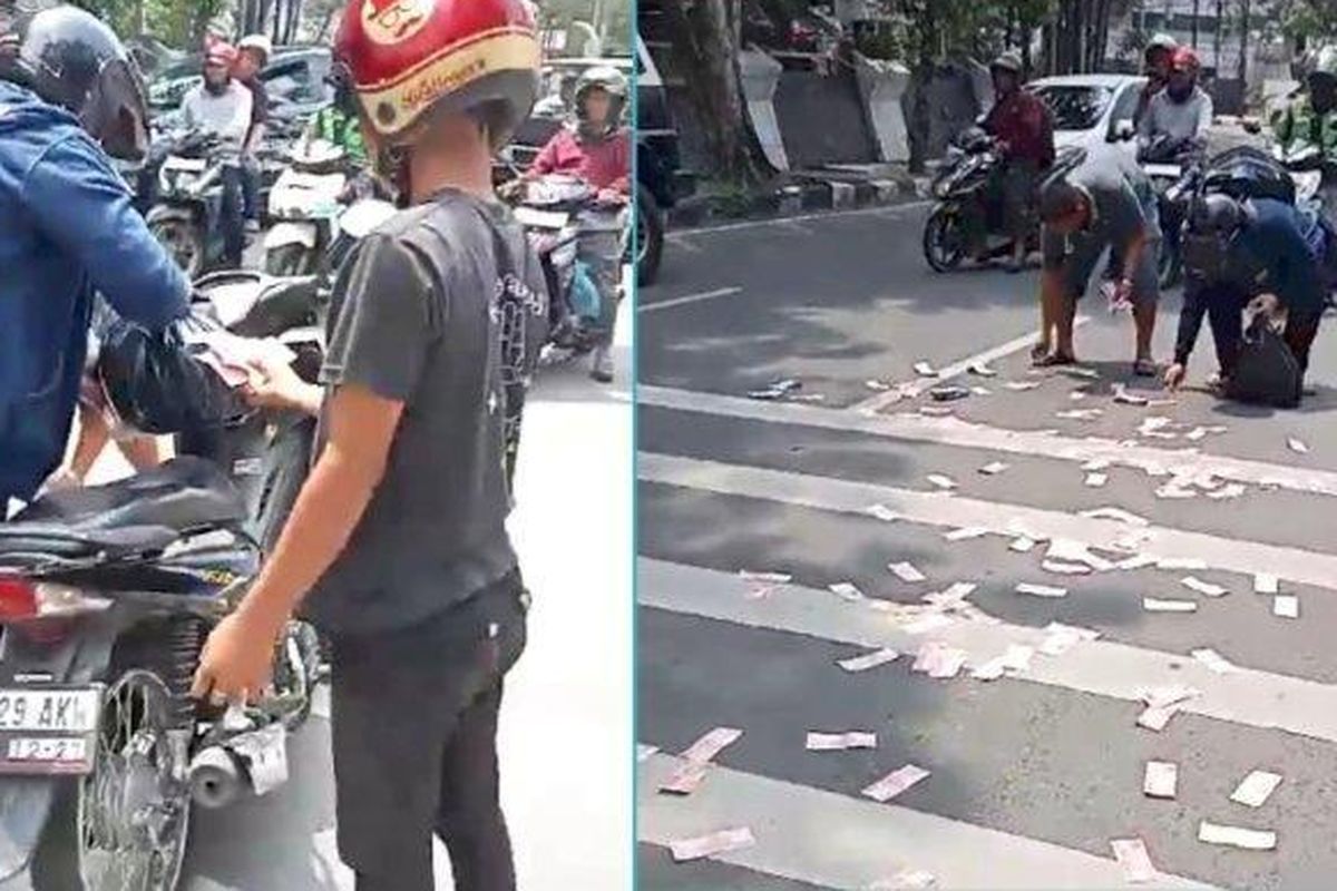 Pengendara berhenti mendadak mengutip uang pecahan Rp 100.000 yang berserakan di Jalan Imam Bonjol Medan, Sumut, Senin (18/9/2023). 

