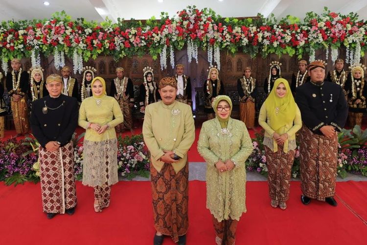 Wali Kota Madiun Maidi bersama istri Yuni Setyawati Maidi, Wakil Wali Kota Inda Raya dan Ketua DPRD Kota Madiun Andi Raya berfoto bersama dengan pasangan yang mengikut nikah massal di rumah jabatan Wali Kota Madiun, Kamis (14/7/2022). 
