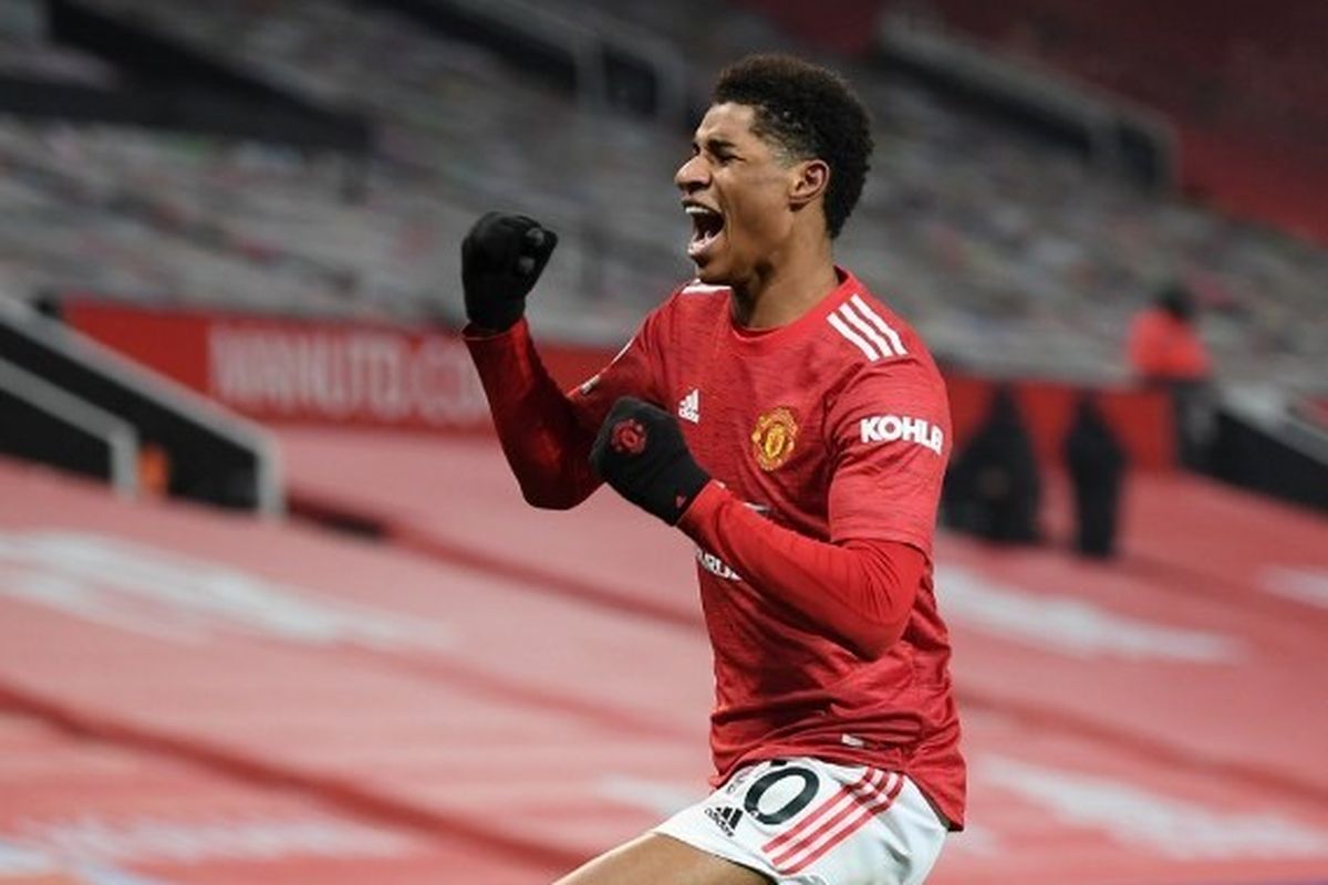 Penyerang Manchester United, Marcus Rashford, merayakan gol kemenangan pada laga Liga Inggris kontra Wolverhampton Wanderers di Stadion Old Trafford, Rabu (30/12/2020) dini hari WIB.