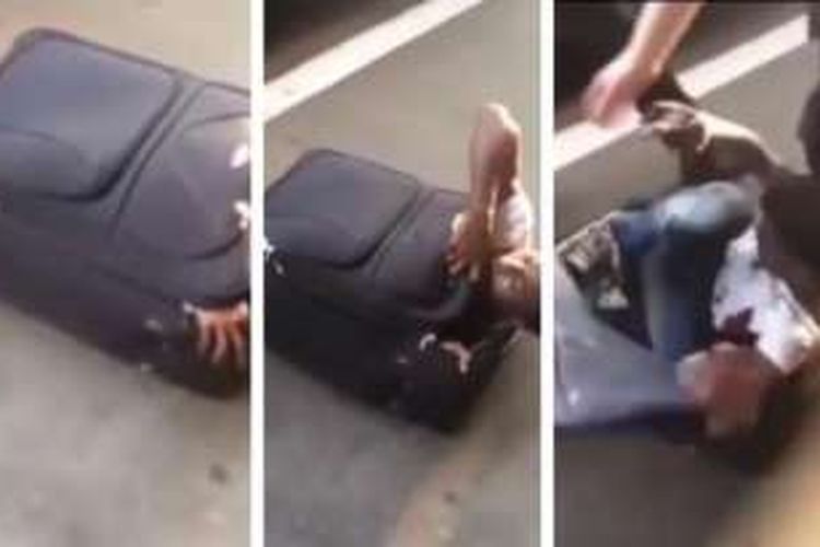 Dalam foto ini terlihat bagaimana pria Eritrea bertinggi badan 1,8 meter keluar dari dalam sebuah koper yang menjadi tempat persembunyiaannya.